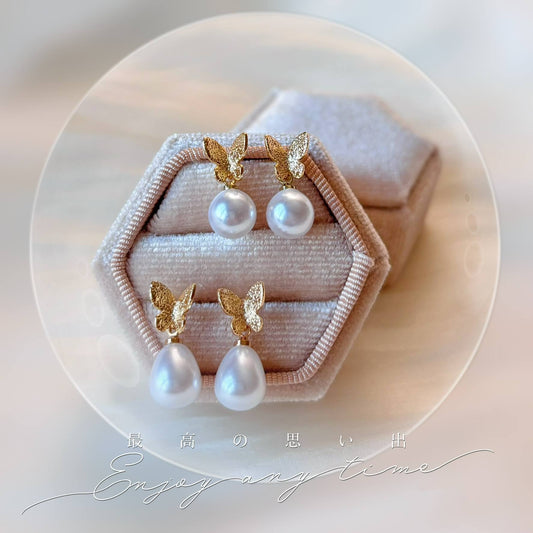 Boucles d'oreilles mariage papillon avec perle ronde, un bijou élégant et intemporel.