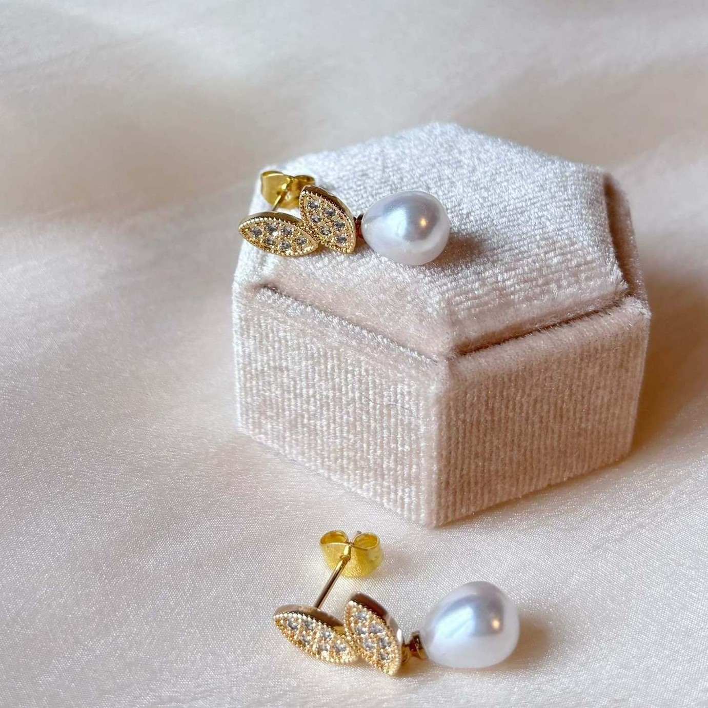 Accessoires de mariage poétiques, feuilles dorées et perle blanche.