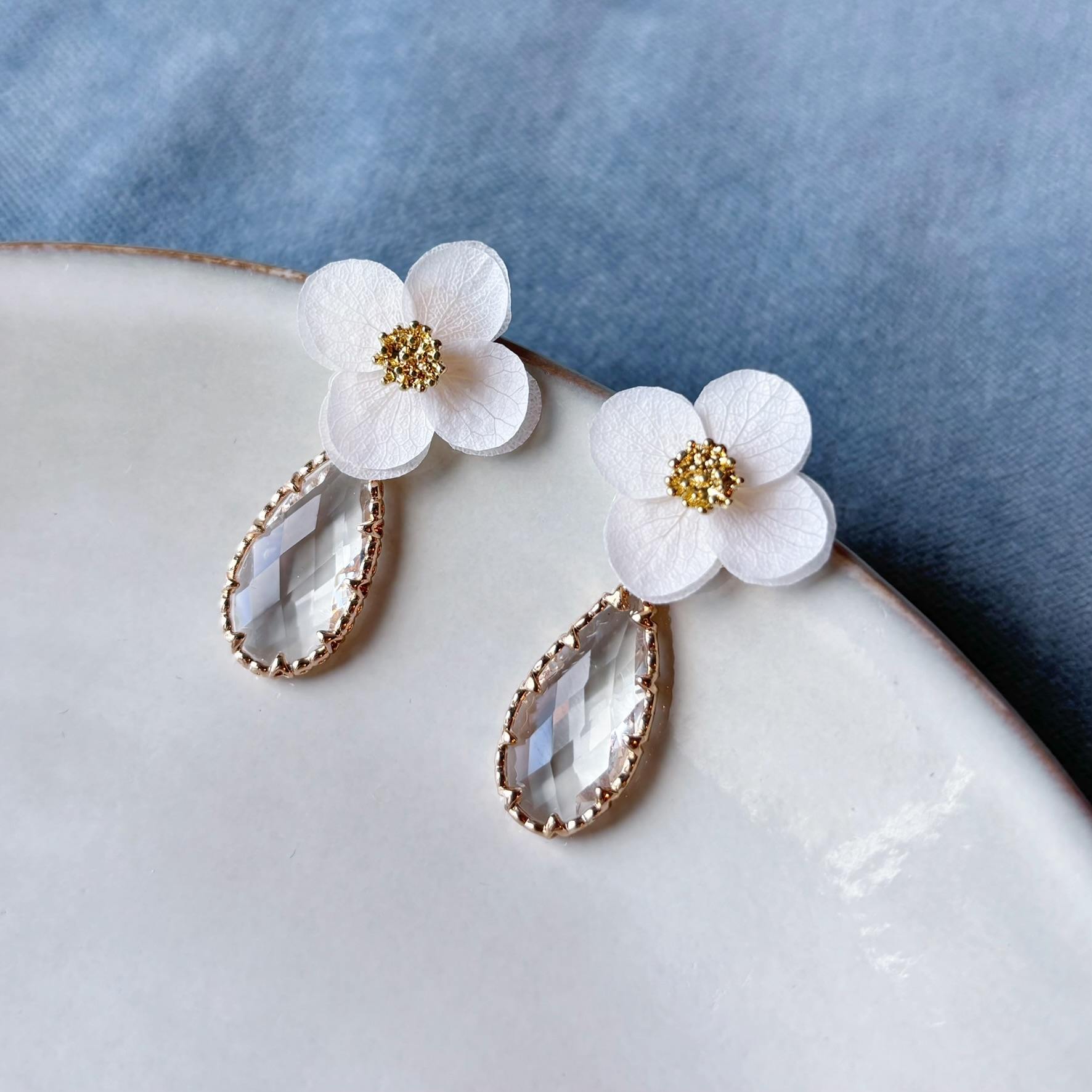 Puces d’oreilles mariage élégantes, fleurs stabilisées et cristal transparent pour mariée