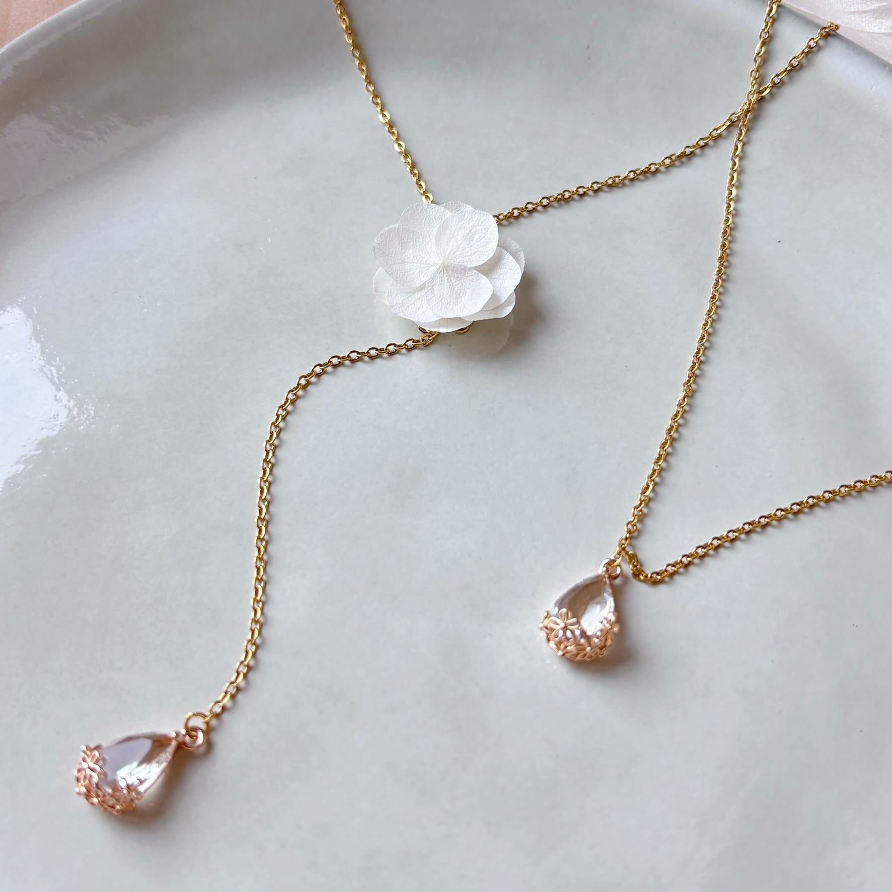 Collier de dos mariage avec fleurs naturelles stabilisées, perles en verre et cristal, création artisanale.